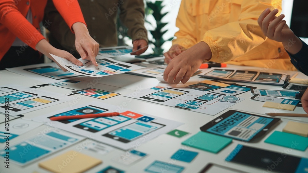 Aufkleber a group of individuals collaborates over a large table, analyzing wireframe mockups and colorful not