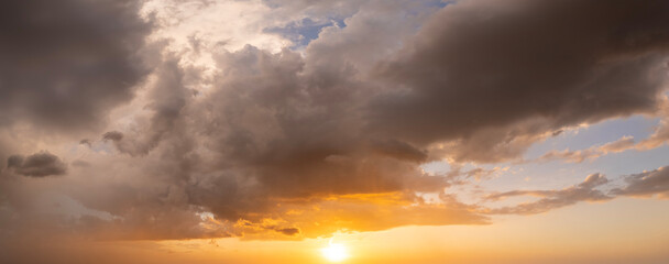 Amazing sunset skyscape. Evening sky with bright colorful orange and yellow clouds