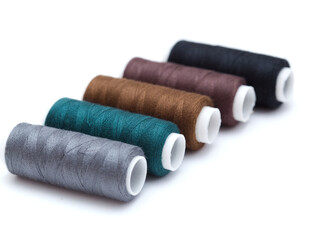 ull cross-wound spools of thin sewing tread