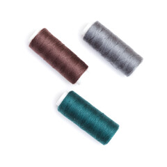ull cross-wound spools of thin sewing tread