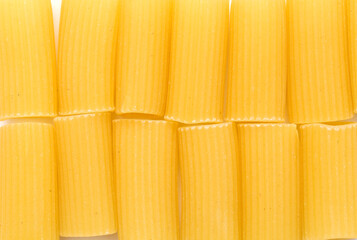 Rigatoni, tube shaped dry pasta with ridges, isolated on white background 