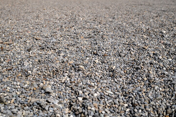 Pebbles close-up with perspective, background with texture, small pebbles, decorative stones