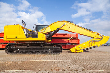 Obraz premium New yellow crawler excavators are parked on the site.