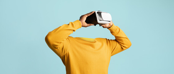 A person engages in virtual reality using advanced goggles, exploring immersive environments. The...