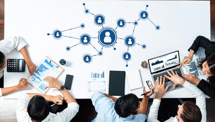 A dynamic office scene featuring a collaborative business meeting focused on data analysis and...
