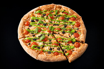 pizza with pesto on a black background