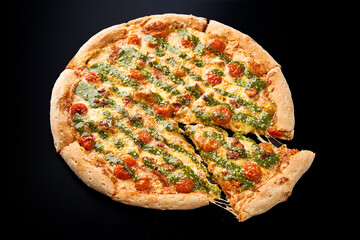 pizza with pesto on a black background