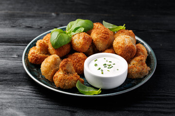 Crispy Breaded Garlic Mushrooms with garlic sauce. Vegetarian, vegan food concept