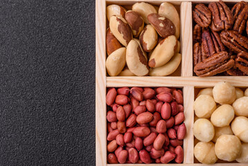 Wooden box with macadamia nuts, Brazil nuts, pecans and peanuts