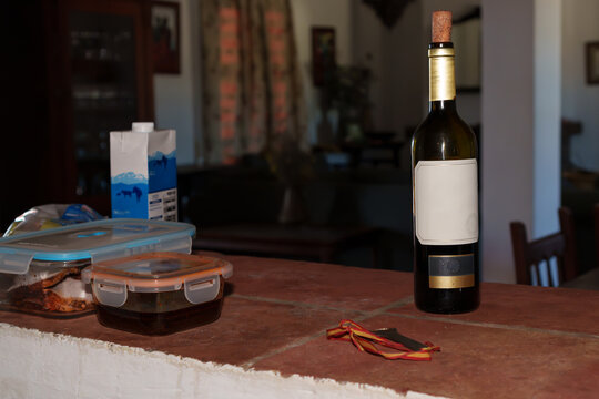 Wine bottle with blank label, on counter -food counter in Taperware