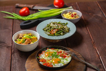 Set table, Jewish food, tzimmes, chelnt, shakshuka and couscous