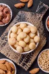 Raw peeled macadamia nut in ceramic bowl