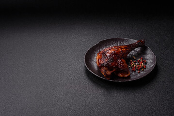 Duck, chicken leg or thigh grilled on a dark concrete background