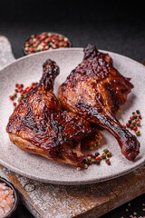 Duck, chicken leg or thigh grilled on a dark concrete background