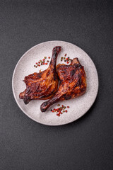 Duck, chicken leg or thigh grilled on a dark concrete background