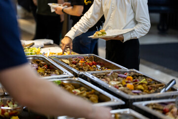Buffet spread displaying a variety of dishes at a catered event in a banquet hall