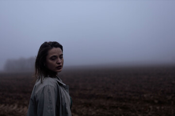  depressed woman in foggy field lonely and sad, 