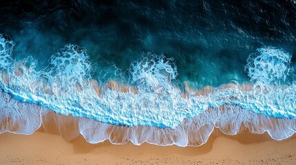 Obraz premium Aerial View of Waves Crashing onto Golden Beach with Turquoise Water and White Foam