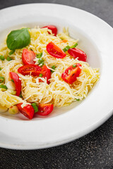 Pasta with tomatoes vermicelli vegetables dish fresh delicious gourmet food background on the table rustic food top view copy space