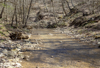 a fragment of a mountain river on a shallow riverbed, the time of the year in nature