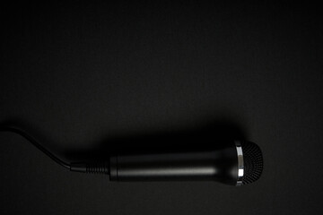 Black microphone on black background