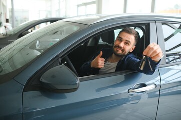 Man customer male buyer client chooses auto wants to buy new automobile