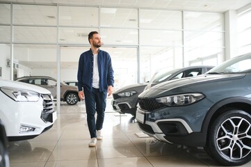 Man customer male buyer client chooses auto wants to buy new automobile