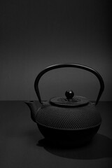 Black matal teapon on black background