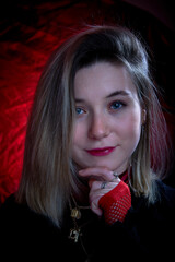 Beautiful portrait of a young girl on a black and red background