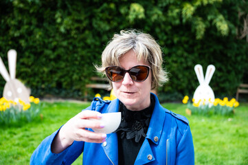 Outdoor portrait of a 39 yo white woman with a blue jacket and sunglasses, Koekelberg, Brussels, Belgium