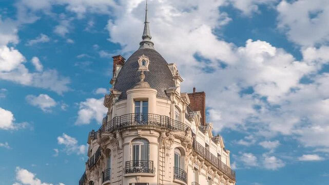 Historic facades at Rue du Languedoc and Theodore Ozenne intersection timelapse in Toulouse, France. Shops, cafes near Carmes metro station in vibrant city center under clouds on a blue sky