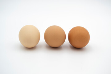 Front view of three brown chicken eggs isolated on white background with clipping path.