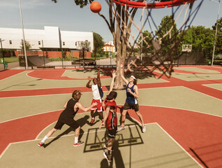 Team of basketball players during match at outdoor court