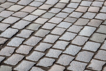 A classic black and white image of a cobblestone street, ideal for use in historical or vintage-themed projects.