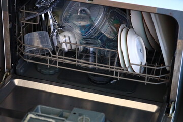 A dishwasher full of dirty dishes waiting to be cleaned.