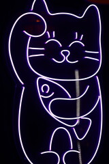 A bright neon sign featuring a cartoonish cat design, suitable for use in nightlife or...
