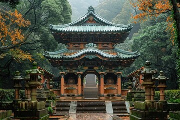 A large ornately decorated gate stands in a misty forested area
