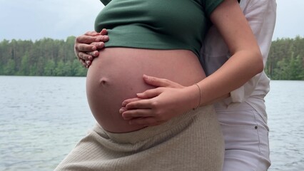 Joyful Anticipation A Couple Embracing Their Expectation of a Baby by the Calm Water
