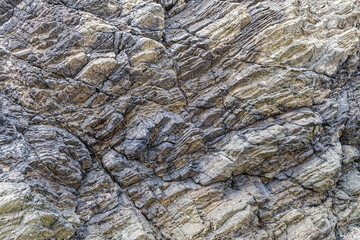 Close up view of the abstract patterns in the rock of a sea stack on the Pacific Coast in Oregon, USA