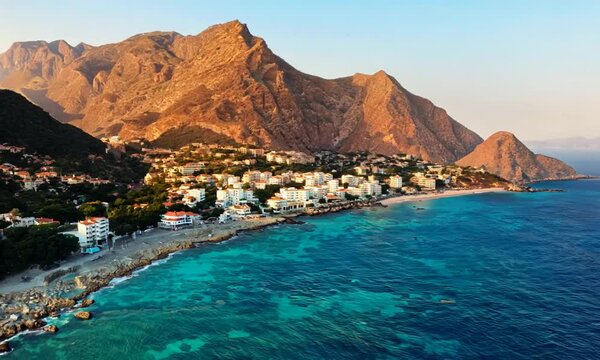 Coastal and mountain grandeur of Turkey coastline azure waters and towering mountains sea and sky. Stunning sea-mountain view of Turkish coastline against backdrop of towering mountains.
