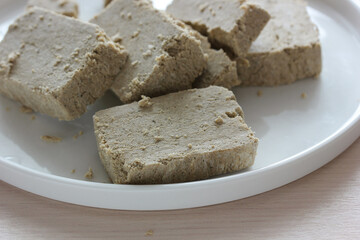 Sunflower halva slices resting on white plate