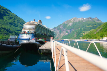 Cruise ship in the fjord. Geiranger Fjord, Norway. Traveling on a Norwegian fjord. Scandinavia....