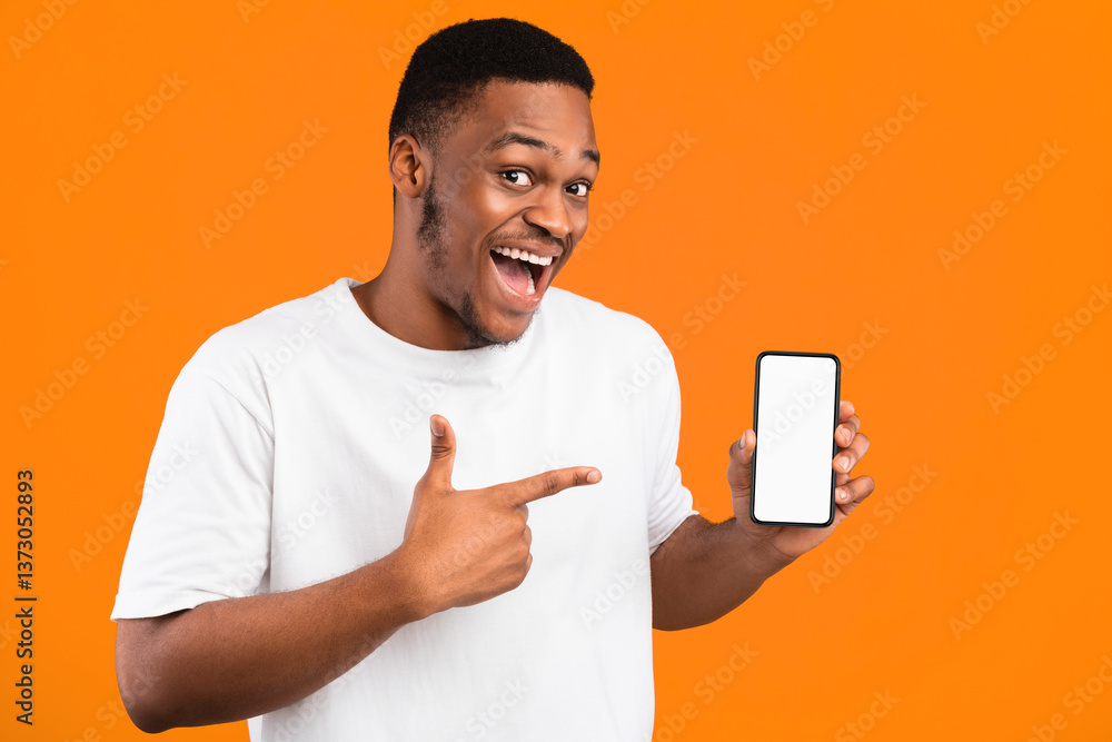 Poster african american guy showing smartphone empty screen recommending mobile application smiling to came