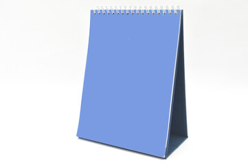 Blank blue paper desk spiral calendar. design dan copy space