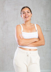 Cheerful young woman in casual clothes standing and smiling