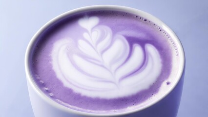 Lavender latte with intricate foam art served in a white cup