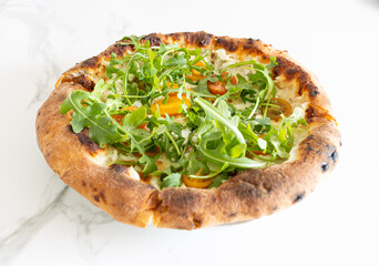Delicious arugula and tomato pizza