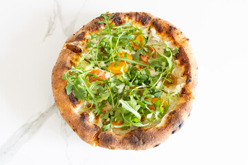 Top view of a delicious arugula and tomato pizza