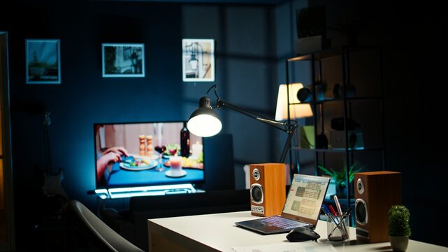 Modern home office in a stylish apartment with wooden furniture and cozy decorations, urban loft. House plants, a smart TV and a creative workspace with a desk setup for a comfortable lifestyle.