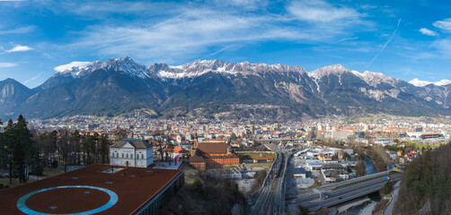 Aerial view of Innsbruck, Austria, featuring historic and modern architecture, roads, bridges, and...